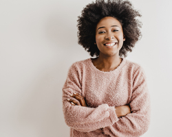 A smiling woman with her arms crossed